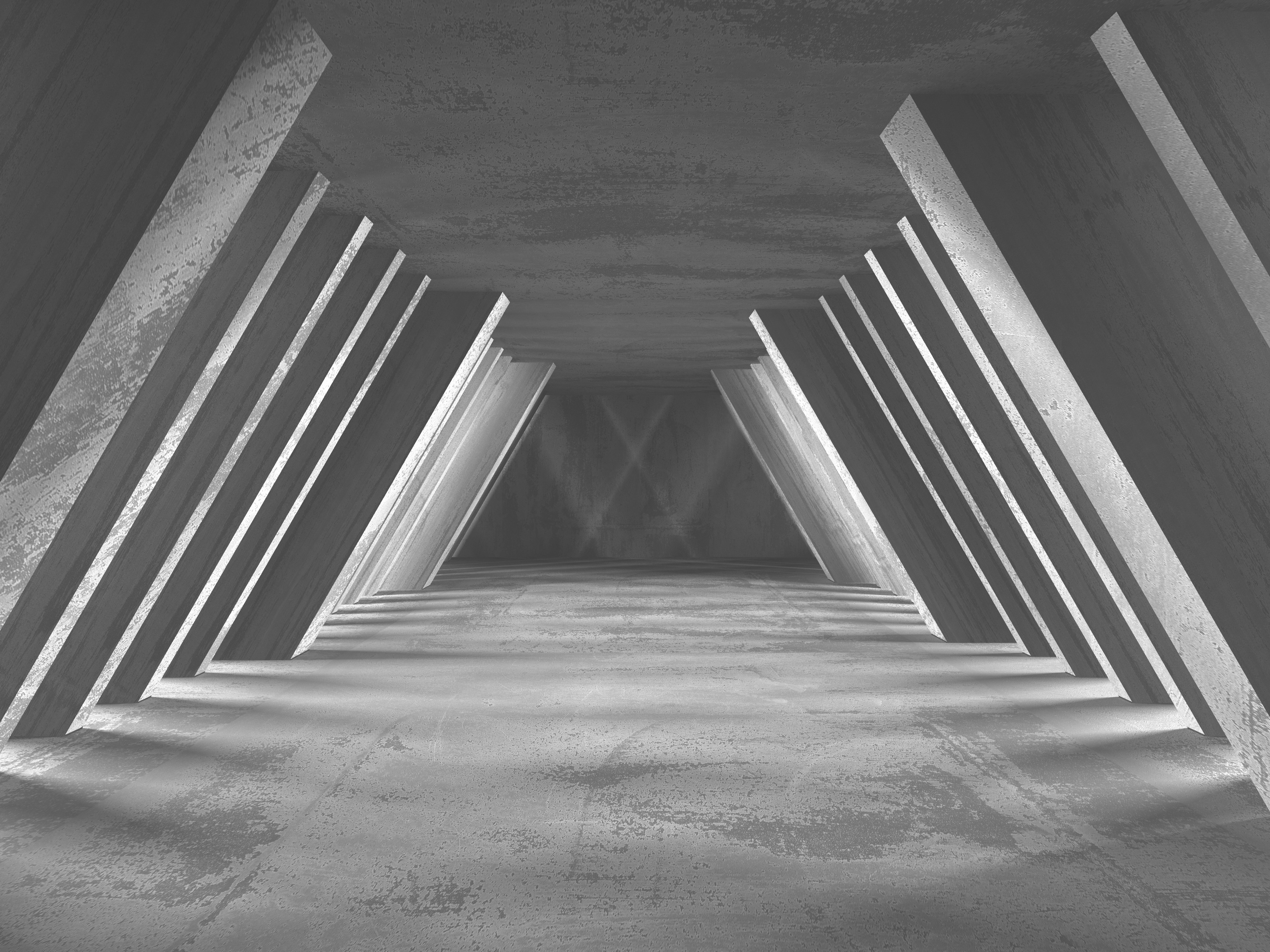 Modern concrete architectural corridor with repeating triangular beams symbolizing the structure and design of effective family wealth meetings.