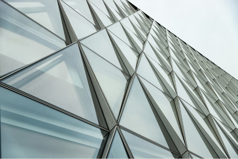 Abstract architectural detail of layered glass panels, suggesting the structured, transparent nature of private placement life insurance design.