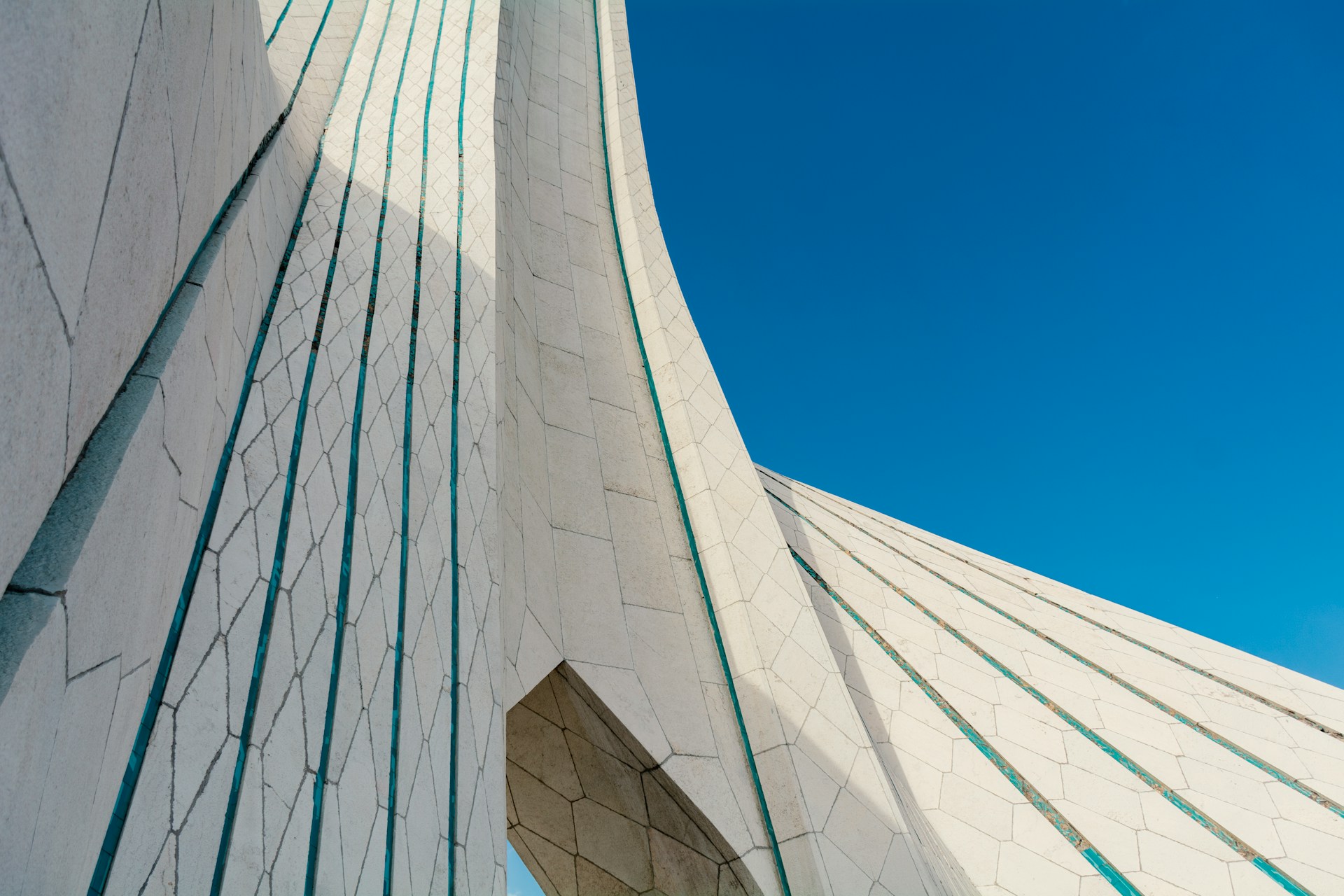 Close-up of a monumental white marble structure with geometric patterning and turquoise inlay lines, symbolizing the enduring framework of family wealth planning